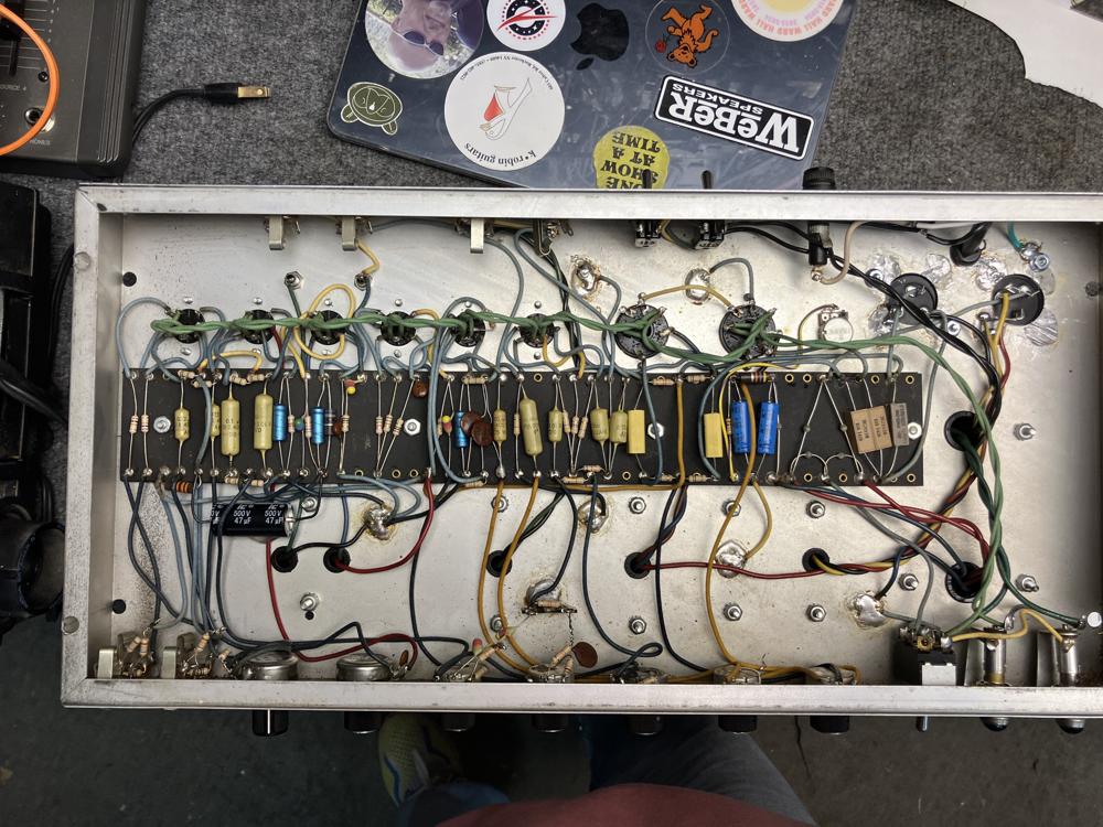 Tube amp chassis open on the bench mid-repair